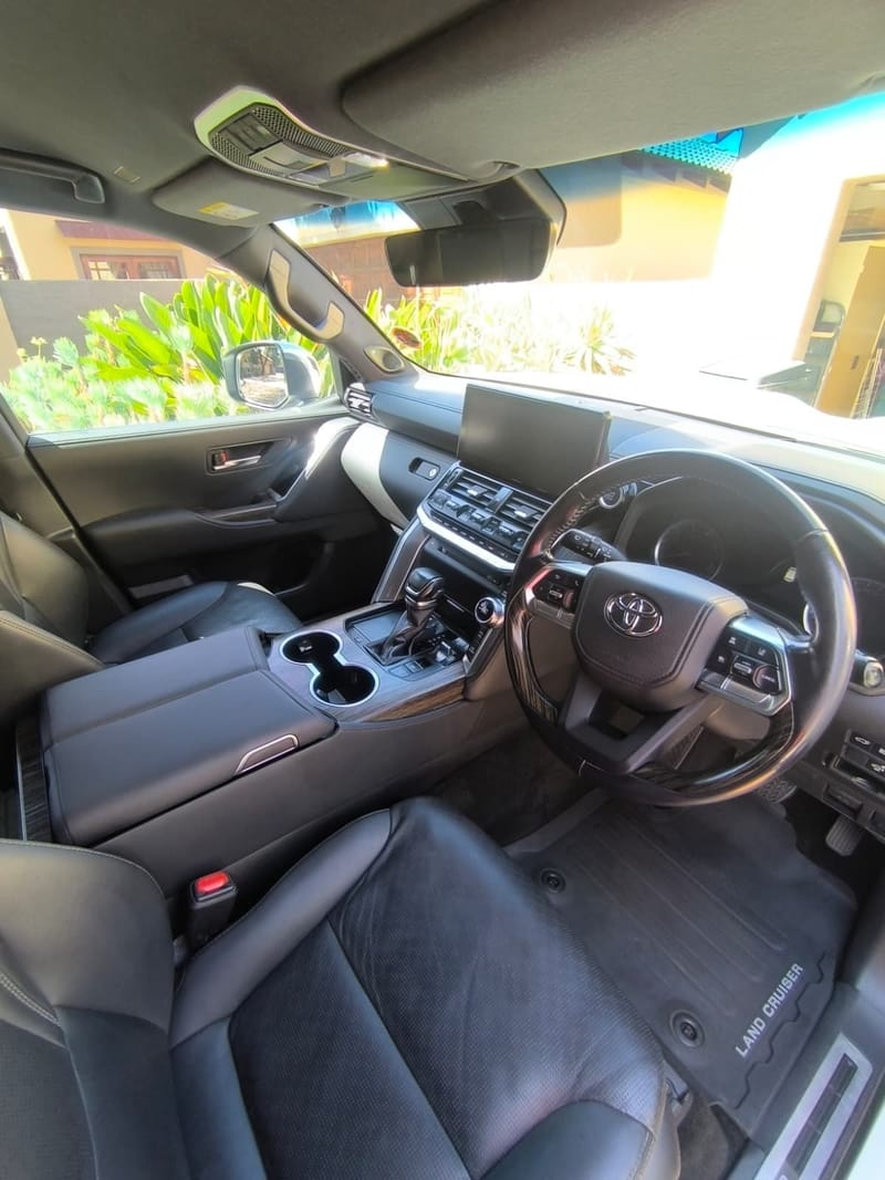 Toyota Land Cruiser 300 cabin after an interior detail, black leather, wood trim and floor mats cleaned