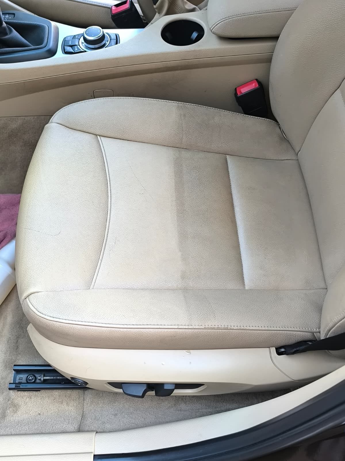 Cream leather seat cleaned and conditioned during an interior valet, showing an even matt finish with no residue