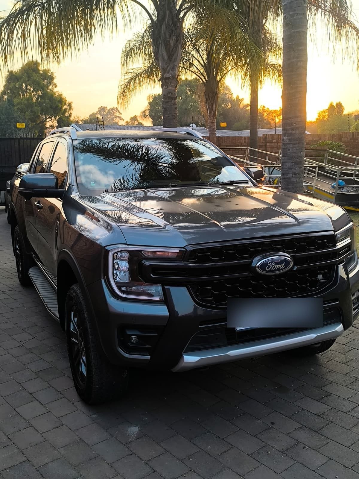 Ford Ranger Wildtrak detailed at golden hour under palm trees on a Johannesburg driveway