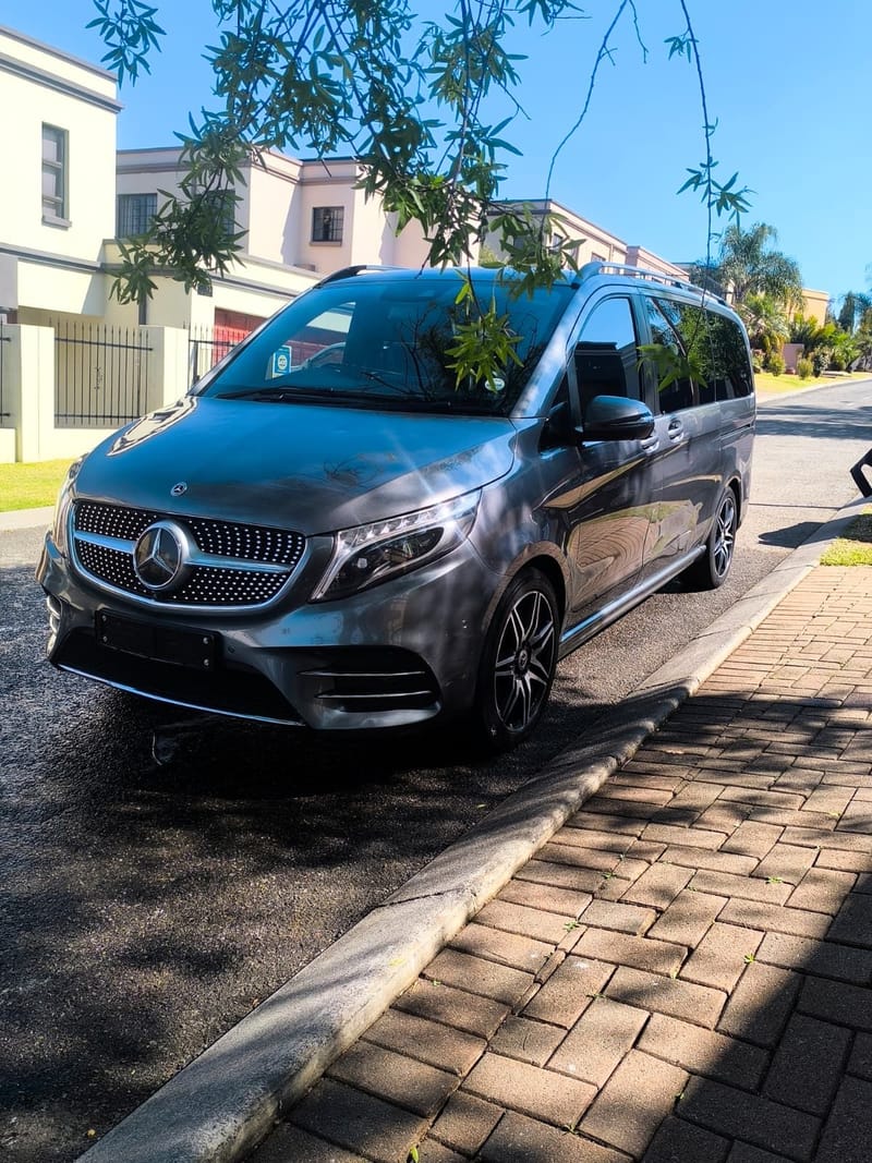Mercedes-Benz V-Class in grey, detailed kerbside outside a Johannesburg home, bodywork reflecting the street