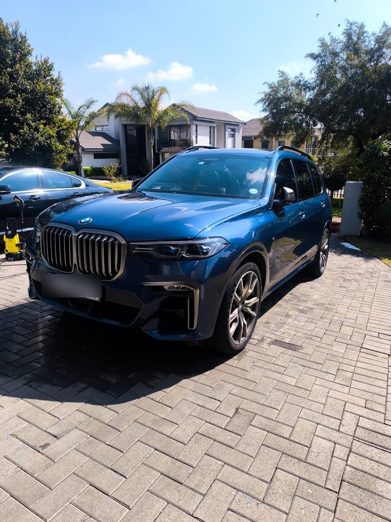 Blue BMW X7 washed and finished on a residential driveway, kidney grille and paint clean
