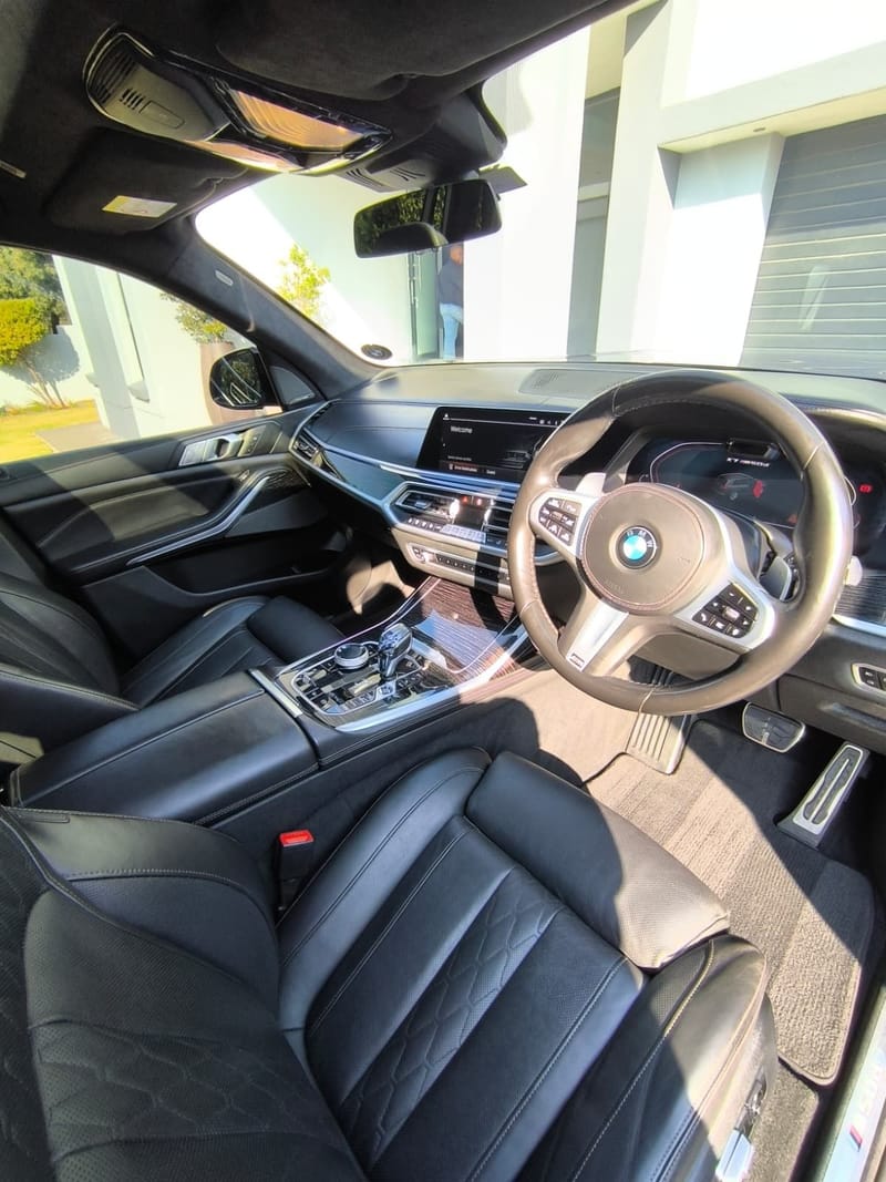 BMW X7 cabin after a full interior detail, quilted black leather seats, dashboard and console cleaned